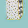 Quilted blanket with square stitching, pattern showing yellow lightning bolts and inside of blanket showing black and white stripes