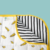 Close up of corner showing black and white striped fabric with a yellow edge, yellow lightning bolt pattern and square quilted stitching